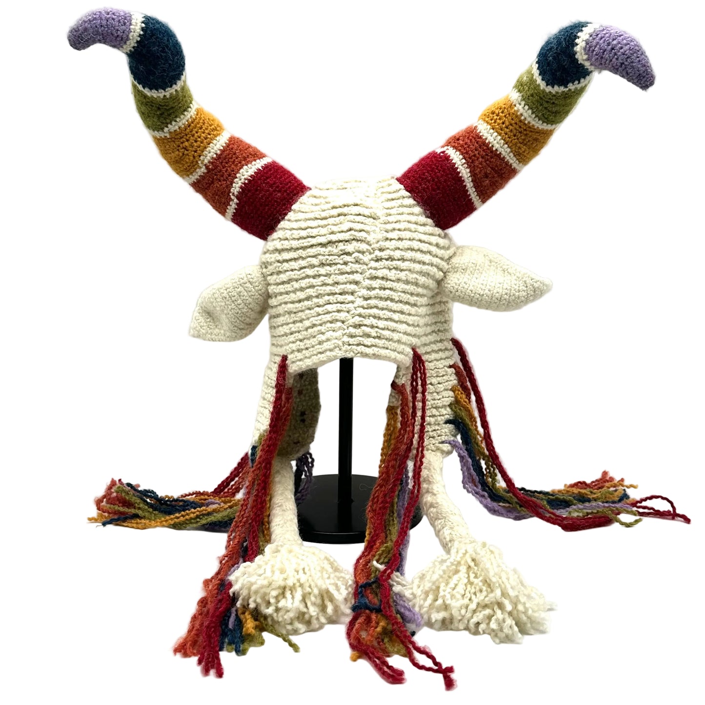 Knitted hat with colorful horns and scarf on a white background