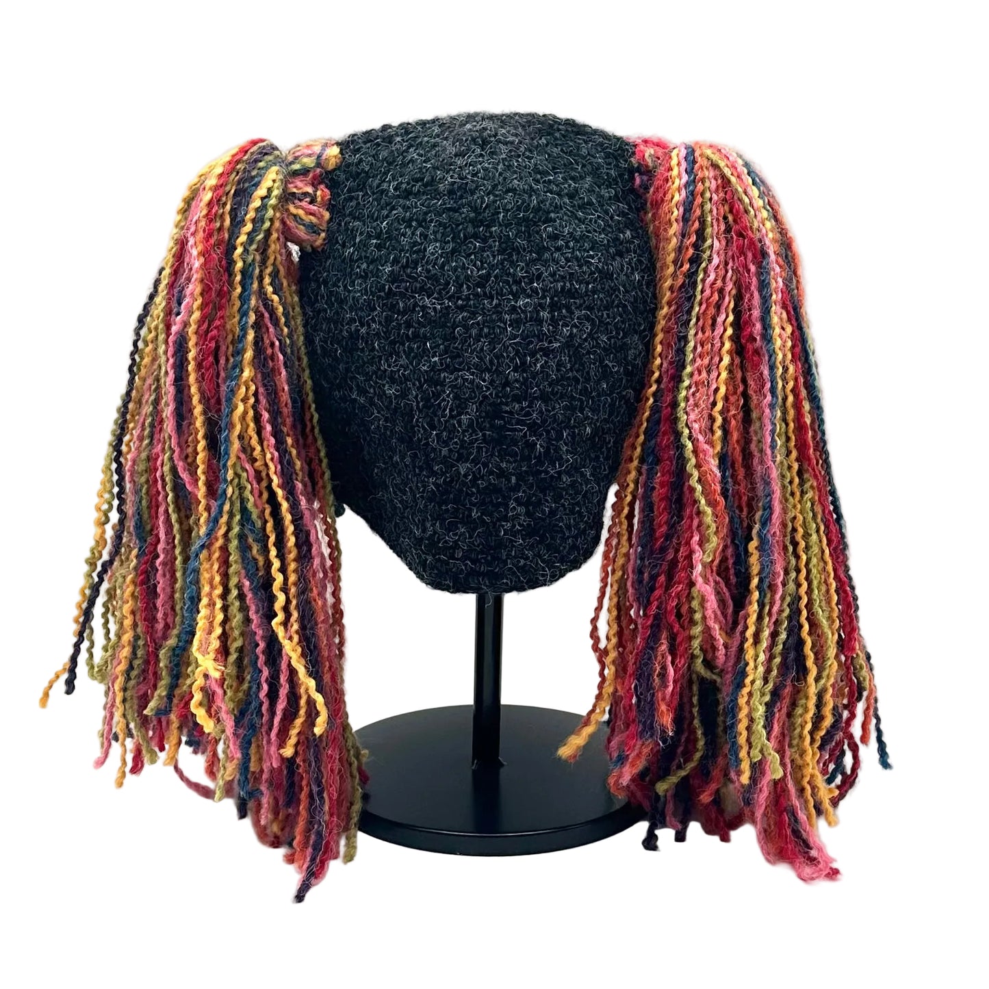 Knit hat with a dark gray and colorful braided extensions on a white background