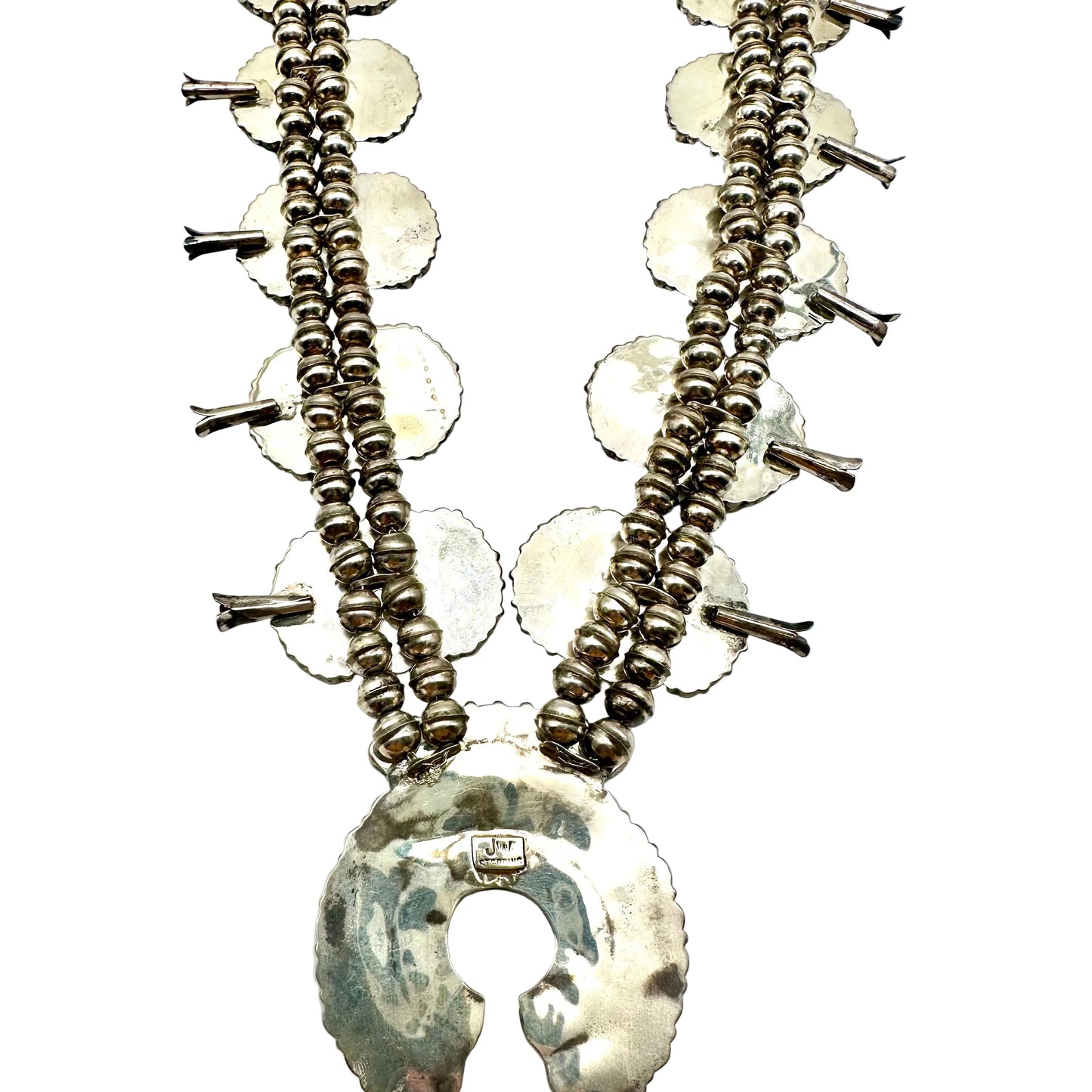 Silver necklace with circular pendants on a white background