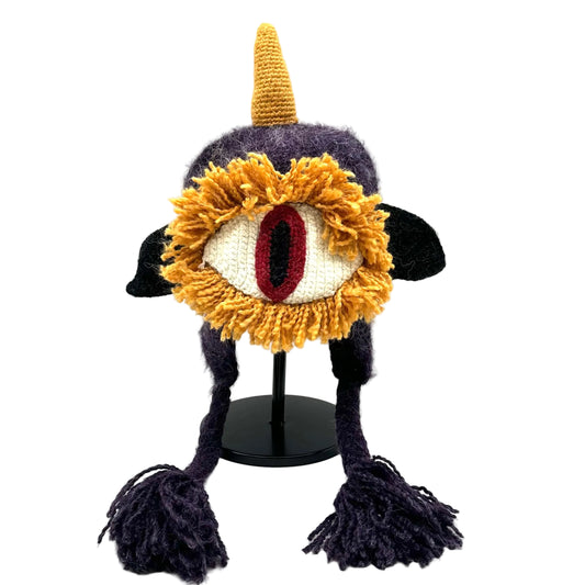 Knitted hat with a large eye design on a white background