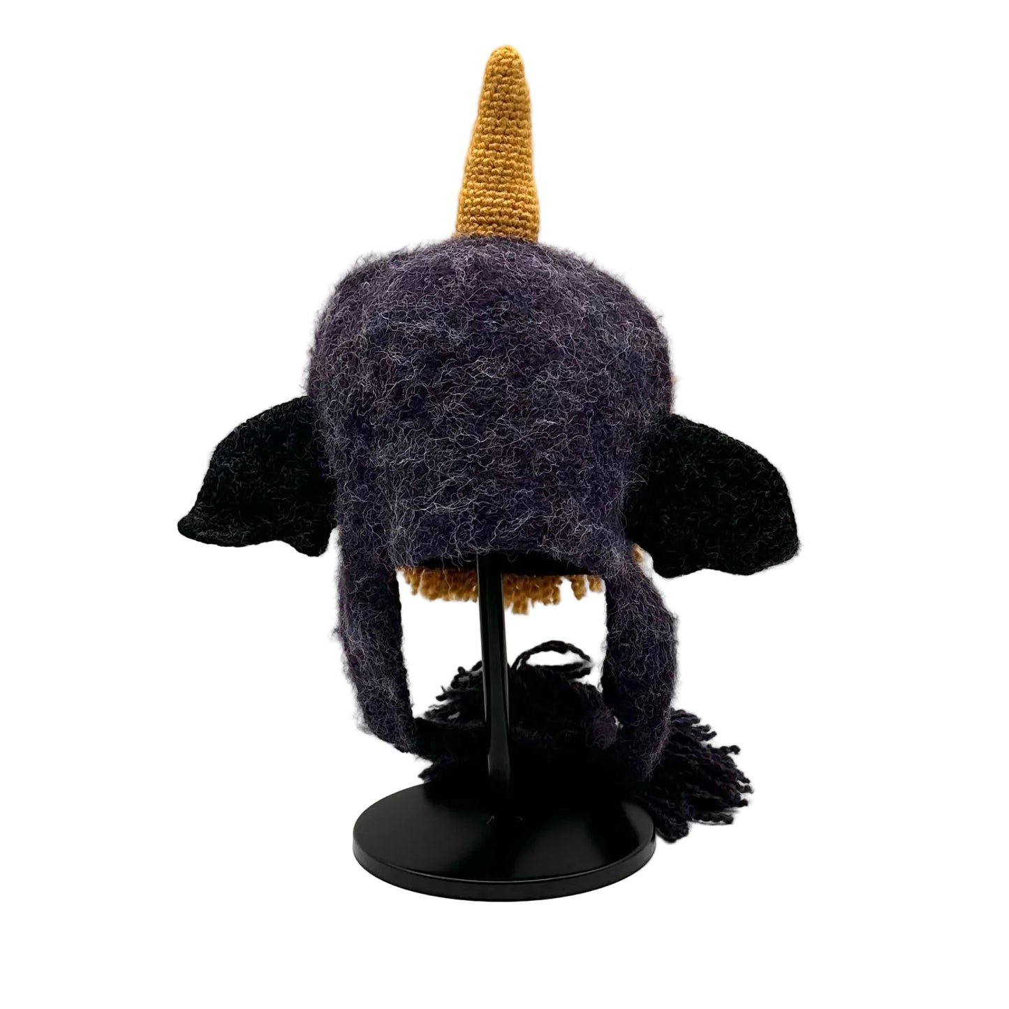 Unicorn-themed hat with a gold horn and black wings on a white background