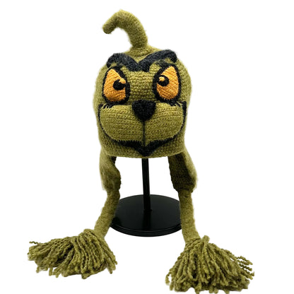 Green crochet hat with long ears and tassels on a white background