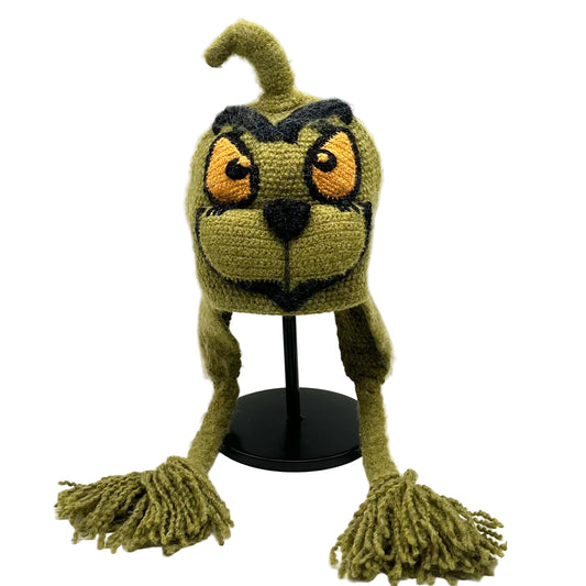 Green crochet hat with long ears and tassels on a white background