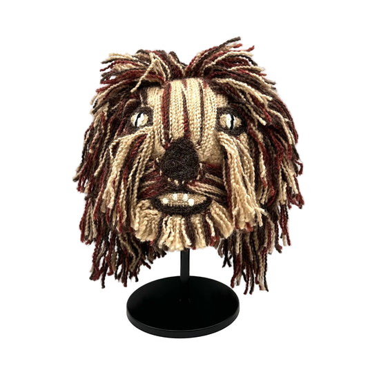 Knitted mask resembling a character with long hair on a white background