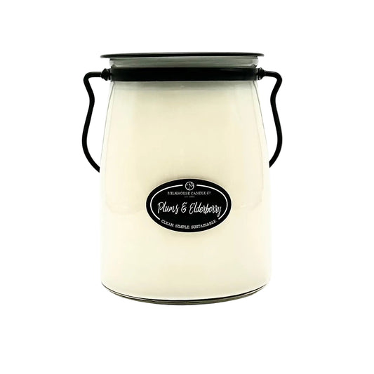White candle jar with black lid and label on a white background