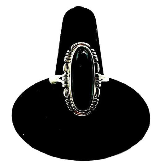 Silver ring on a black stand against a white background