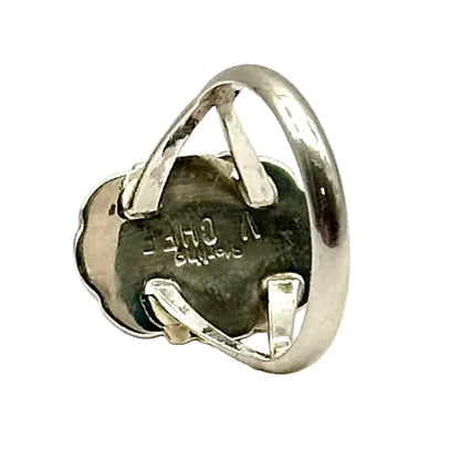 Silver ring with a dark stone on a white background